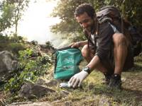 Traveller collecting litter along wilderness trails, part of our 10 Pieces litter collection program |  <i>Mark Tipple</i>